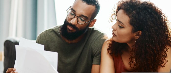 Two people reading papers